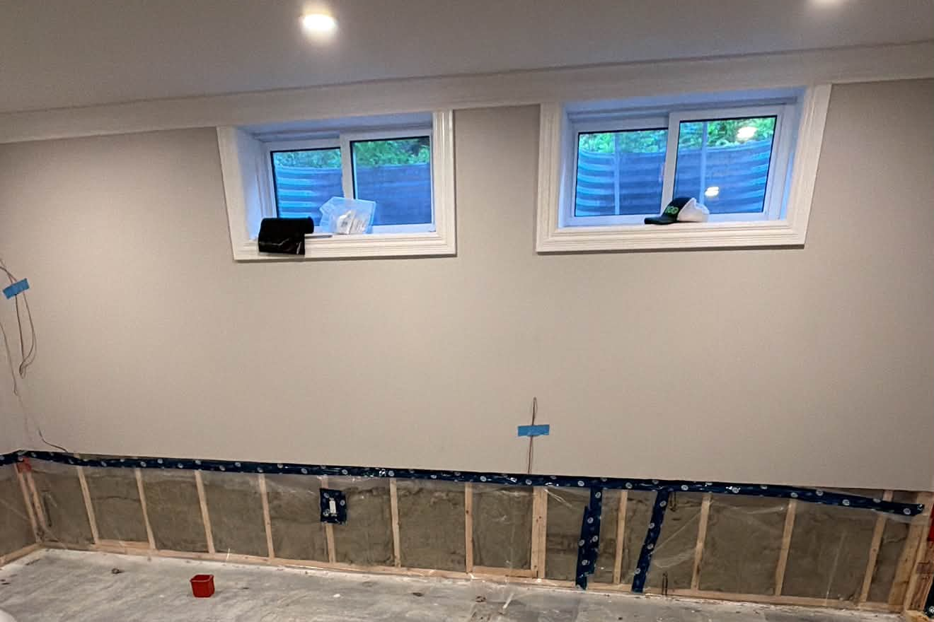 Basement under renovation with framed stud walls and insulation