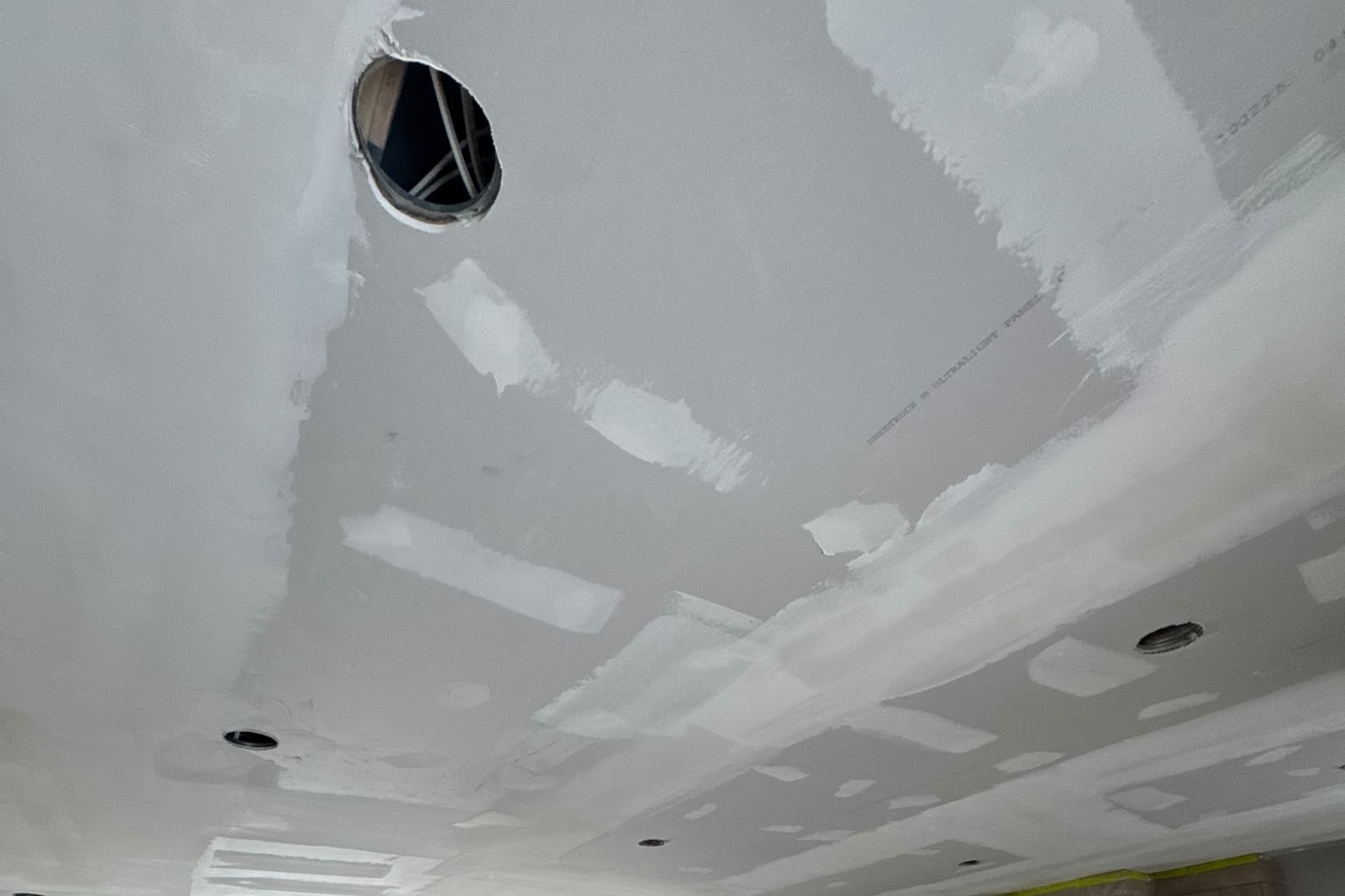 Ceiling drywall repair with patched pot light hole