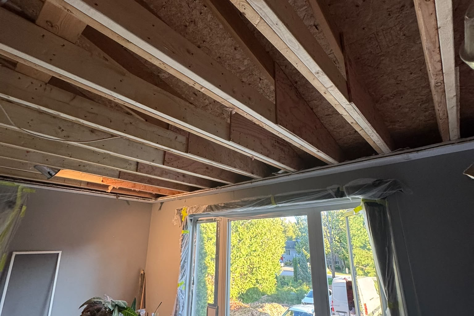 New window installed with ceiling framing exposed
